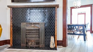 A fireplace with a honeycomb design, a wooden mantel, and a glass vase with candles. - Fun, family friendly stay in Niagara Falls (Niagara Falls)