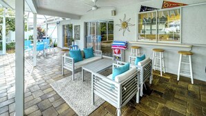 A sunlit patio with outdoor seating, a pool, and a view of the surrounding area. - Tropical Family Pool Home Near Siesta Key Beach | Sleeps 9 Dog Friendly,( Check restrictions)| Gulf Gate Sarasota | Sleeps 9 (Sarasota)