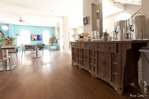 Cozy living area with a wooden cabinet, television, and comfortable seating.