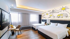 A hotel room with two beds, a desk, a chair, and a TV. - YELLO Hotel Harbour Bay Batam (Batam)