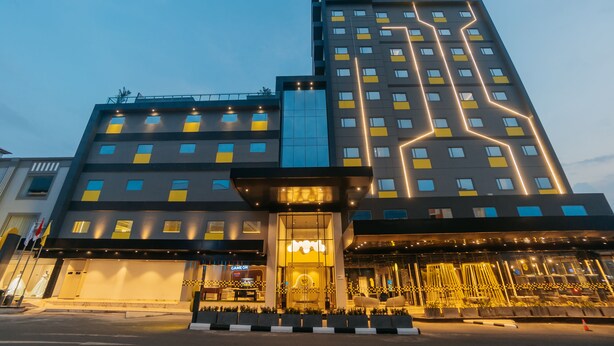 A modern hotel with a prominent 'Hello Hotel' sign, a glass entrance, and a well-lit facade. - YELLO Hotel Harbour Bay Batam (Batam)
