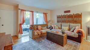 A cozy living room with a sofa, a coffee table, and a patterned rug. - Lovely Concord Townhome Retreat w/ Community Pool! (Concord)