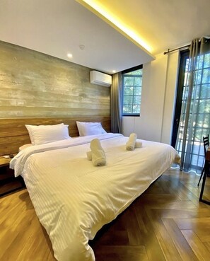 Relax in comfort with a large bed, wooden headboard, and air conditioning unit.