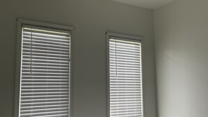 A bedroom with two windows, a ceiling fan, and a bed with pillows. - The Resting Place Apt 1  Keep it simple at this peaceful & centrally located Apt (Marion)