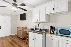 Fridge, microwave, coffee/tea maker, cookware/dishes/utensils