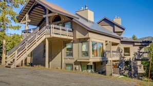 A two-story house with a prominent staircase leading to a balcony. - Cozy Condo w/ Balcony - Near Big Sky Resort! (Big Sky)