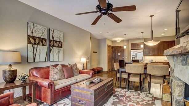 A spacious living room with a leather sofa, a coffee table, and a fireplace. - Waterhouse 5109 (Breckenridge)