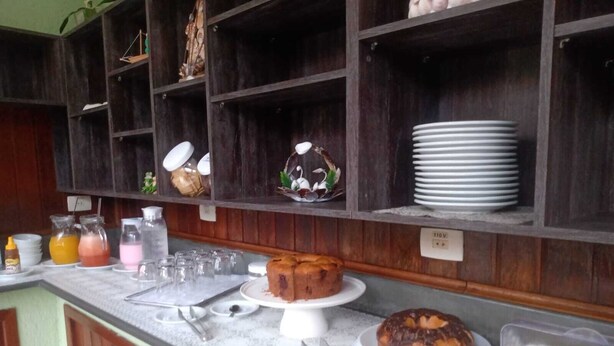 A breakfast buffet with various food items and beverages. - Pousada Sol e Lua (Caraguatatuba)