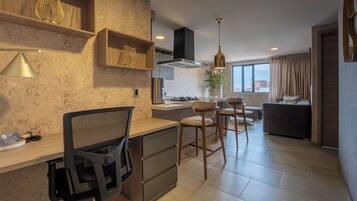 A modern kitchen with wooden shelves, a dining area with bar stools, and a view of the city through large windows.