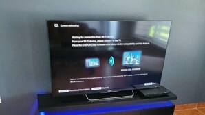 A television on a stand with a screen displaying a screen mirroring message. - Cozy family home in quiet area, nice garden views. (Miami)