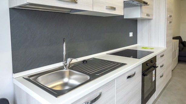 A modern kitchen with a stainless steel sink, a built-in oven, and light-colored cabinetry. - SE029 - Mondolfo, new three-room apartment with balcony and air conditioning (Mondolfo)