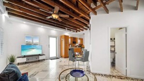 A modern living room with a TV, sofa, and coffee table. - Waterside Escape w/Queen Bed and Free Parking (Hollywood)