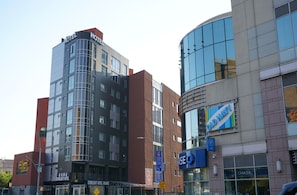 Hotel features a striking glass and brick facade with large windows.