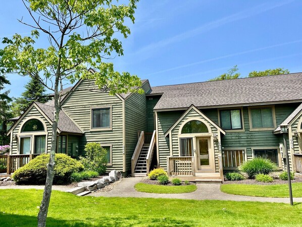 A row of two-story houses with a central entrance and a small porch. - Relaxing Mountain Condo with Fireplace & Deck (Somerset)