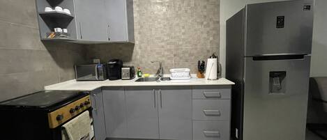 Fridge, coffee/tea maker, toaster, cookware/dishes/utensils