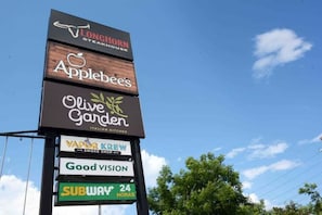 Signs for various local businesses line the structure.
