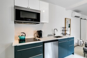 A modern kitchen with a built-in microwave, stove, and dishwasher.