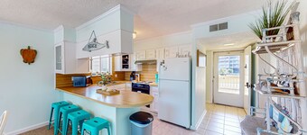 Light-filled coastal stay with open layout, water views, washer/dryer, and AC