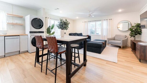 A modern apartment with a kitchen, dining area, and living room. - Pet-Friendly St. Simons Island Beach Rental | The Blue Pearl (Saint Simons Island)