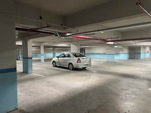 A parking garage with multiple levels, concrete floors, and blue and white walls. - Urban Luxury- Studio Living in San Telmo Num5044 (Buenos Aires)