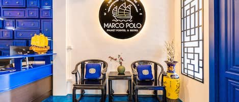 A reception area with a logo for Marco Polo, featuring a nautical theme and a blue color scheme.