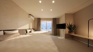 A modern hotel room with a large bed, a flat-screen TV, a potted plant, and a balcony with a view. - Crystal Villa SHIRARAHAMA BEACH (Shirahama)