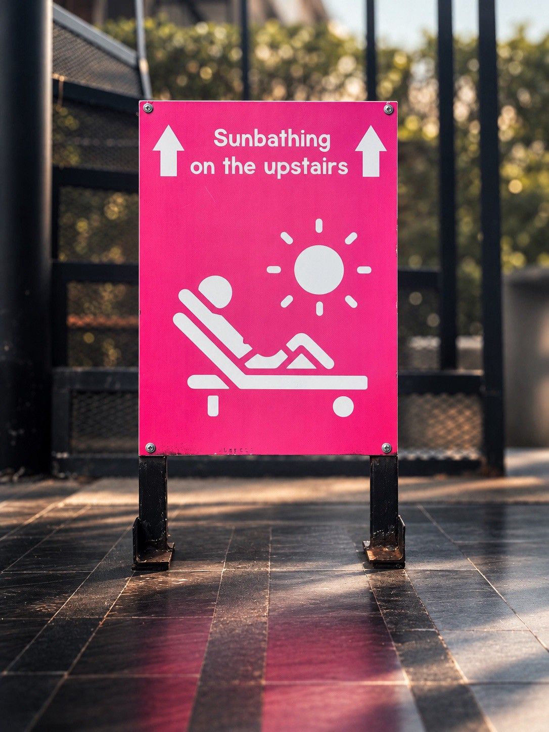 A sign indicating sunbathing on the upstairs area.