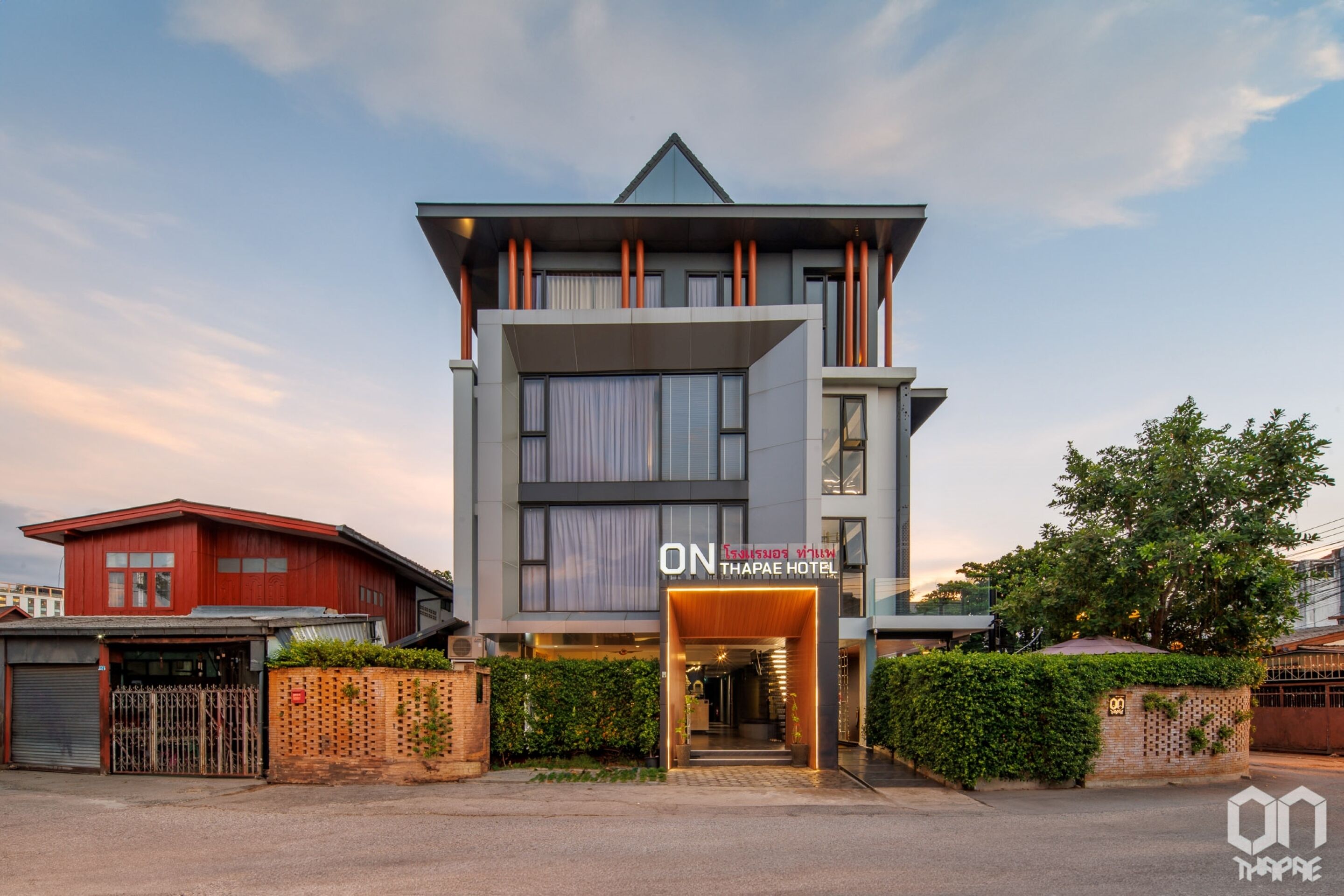 A modern hotel with a prominent entrance, a visible name sign, and a structured facade.
