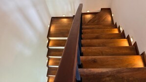 A wooden staircase with a handrail, leading upwards. - Windy Hanthana (Kandy)