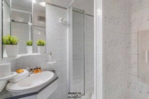 Shower, hair dryer, towels, toilet paper