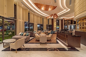 Relax in our spacious lobby with sofas and armchairs, surrounded by large windows offering a view of the outside.