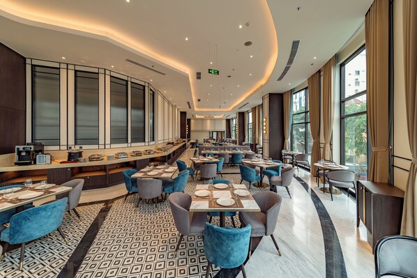 A spacious restaurant with high ceilings, large windows, and a modern interior design.