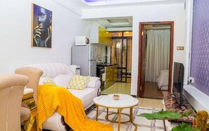 City Apartment | Living area | 24-inch Smart TV with digital channels - Lux Suites Marcus Apartments Kilimani (Nairobi)