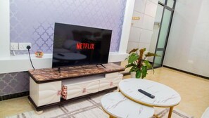 City Apartment | Living area | 24-inch Smart TV with digital channels - Lux Suites Marcus Apartments Kilimani (Nairobi)