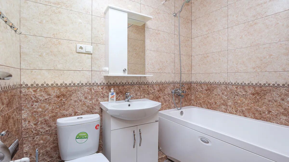 A bathroom with a sink, toilet, and bathtub.
