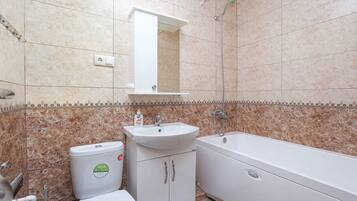 A bathroom with a sink, toilet, and bathtub.