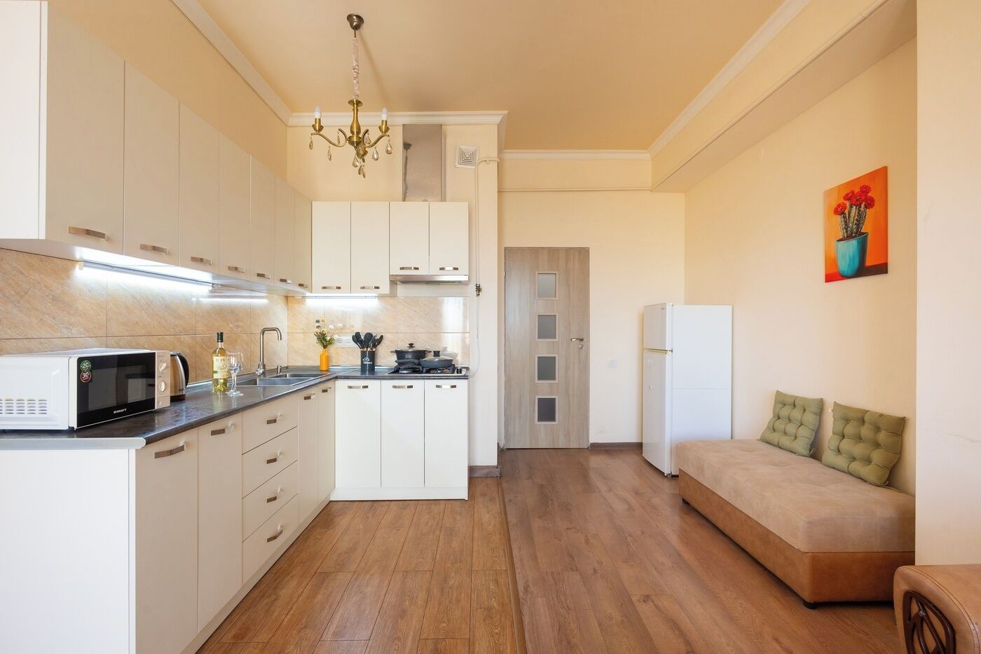 A compact kitchen with a microwave, stove, and refrigerator.