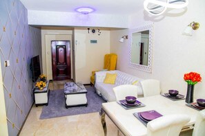 Business Apartment | Living area | 24-inch Smart TV with satellite channels - Lux Suites Marcus Garden Apartments (Nairobi)