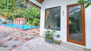 A modern building with a pool area, including a swimming pool and a covered patio. - Vivian riverside cottage - Ninh Bình (Ninh Binh)