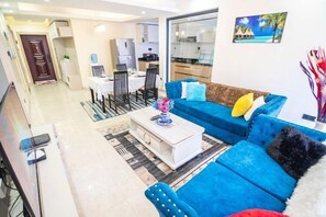 Deluxe Apartment | Living area | 24-inch Smart TV with digital channels - Lux Suites Urban Oasis Apartments (Nairobi)