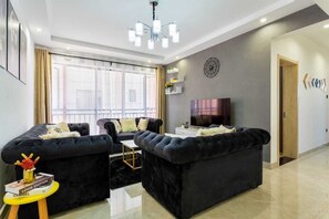 Business Apartment | Living area | 24-inch Smart TV with digital channels
