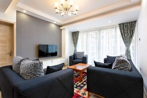 Elite Apartment | Living area | 24-inch Smart TV with digital channels - Lux Suites Urban Oasis Apartments (Nairobi)