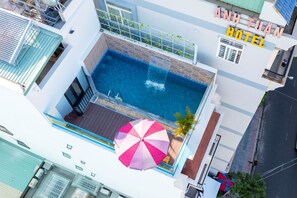 An aerial view of a hotel with a swimming pool, a large umbrella, and a sign reading "ANH TUAN HOTEL". - Gold Holiday Hotel (Ho Chi Minh City)