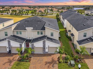 A residential area with modern houses, a well-maintained lawn, and a clear view of the surrounding neighborhood.