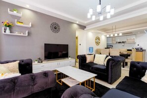 Business Apartment | Living area | 24-inch Smart TV with digital channels - Lux Suites Oasis of Peace Apartments (Nairobi)