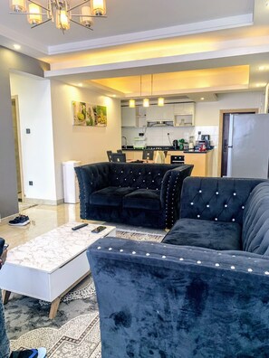 Deluxe Apartment | Living area | 24-inch Smart TV with digital channels - Lux Suites Oasis of Peace Apartments (Nairobi)