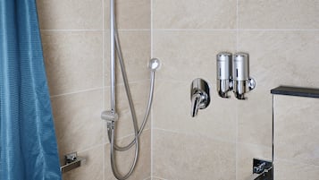 A shower area with a handheld showerhead, a wall-mounted faucet, and two wall-mounted water dispensers.