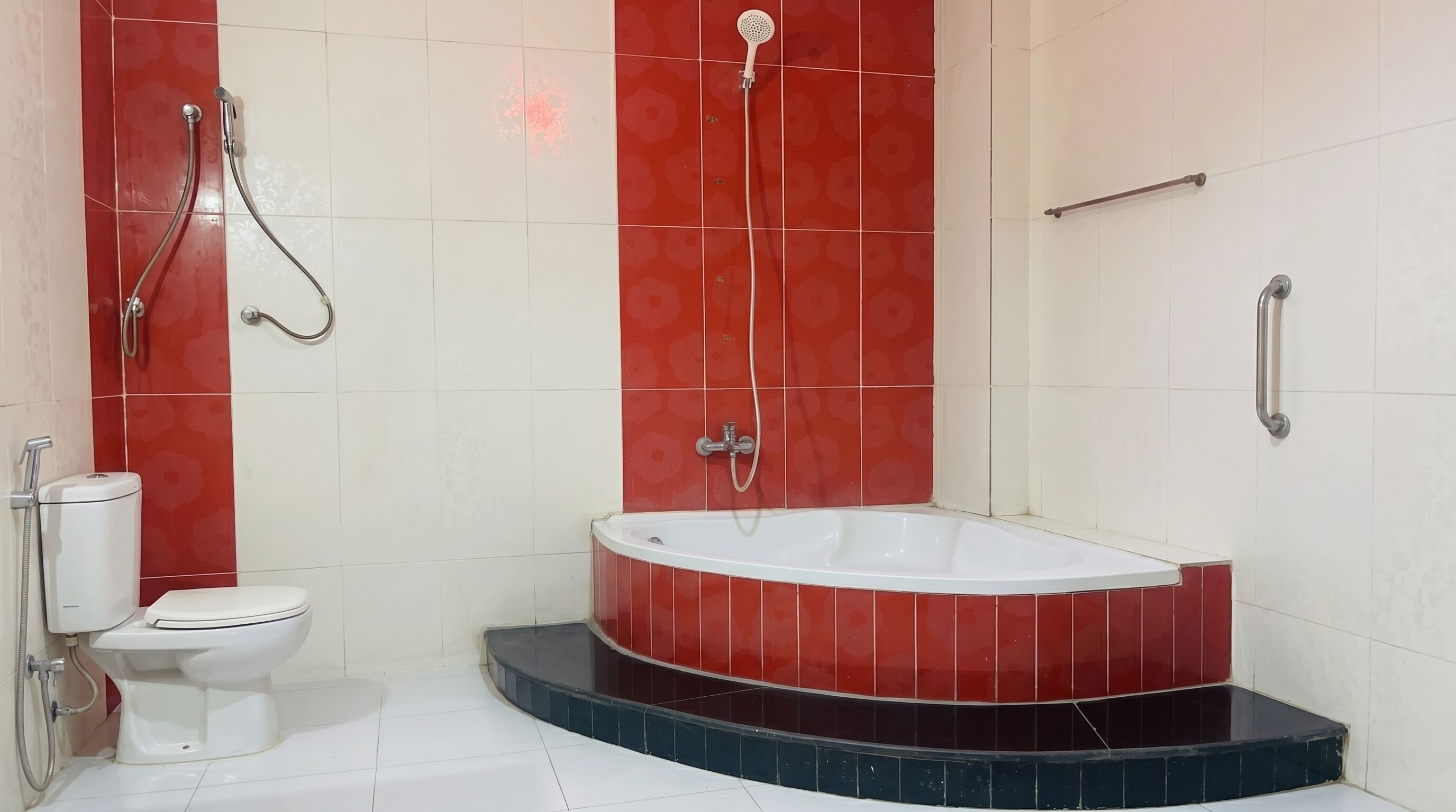 A bathroom with a bathtub, toilet, and shower.