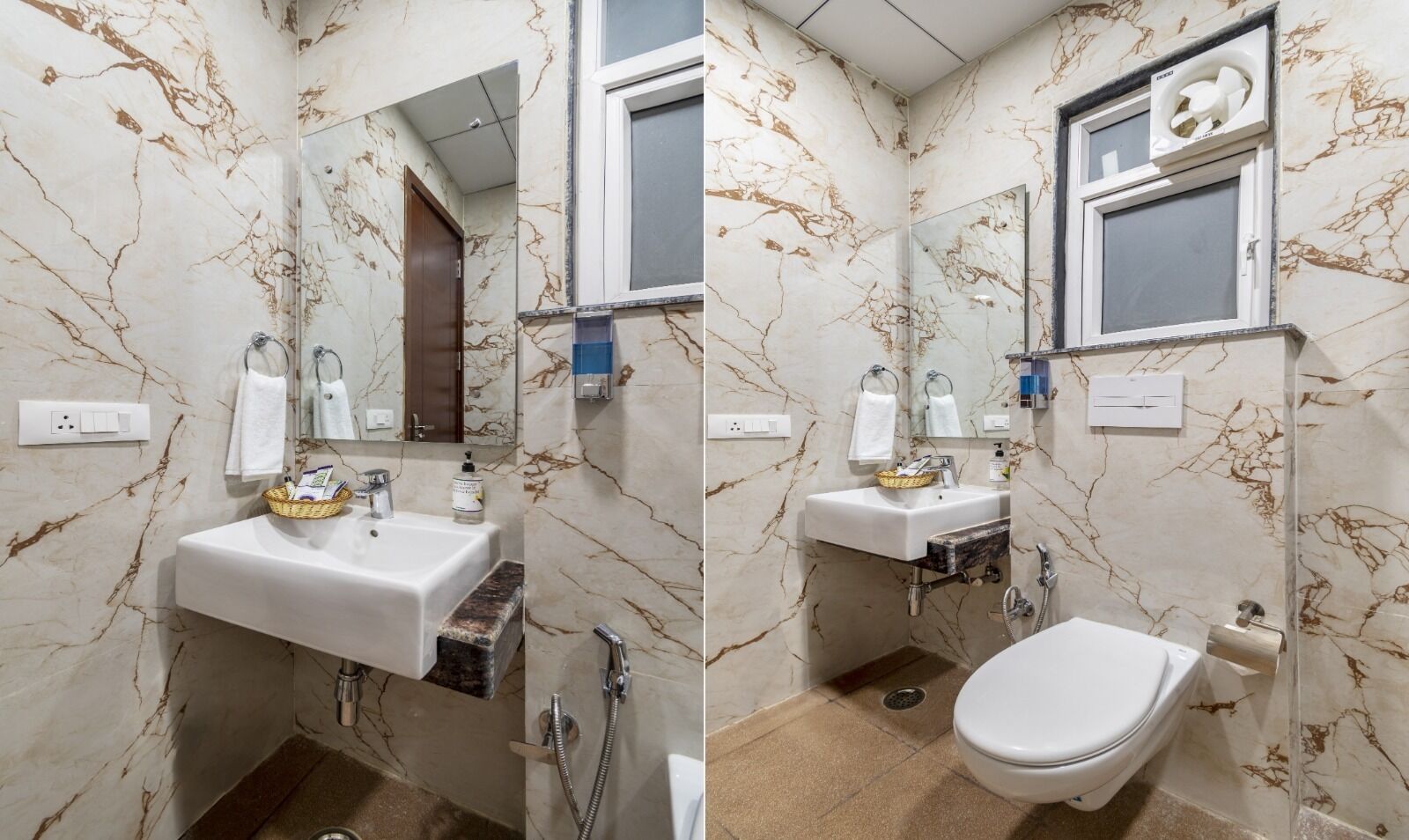 A bathroom with marble walls, a white sink, a mirror, a window, and a toilet.