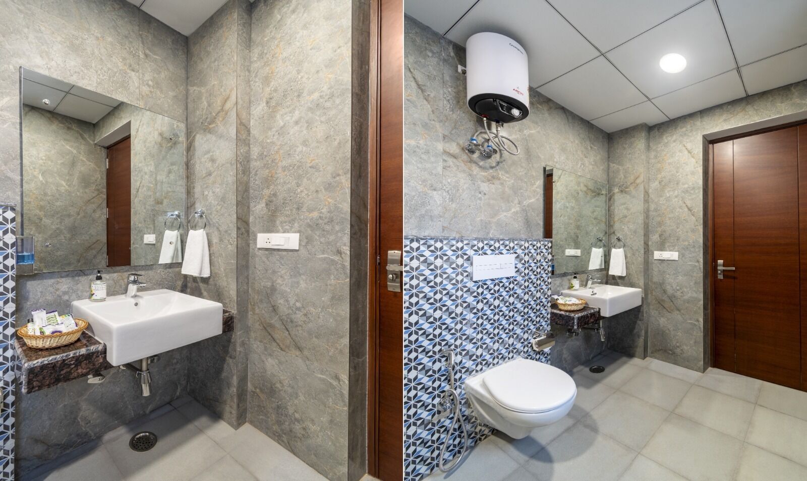 A bathroom with a marble wall, a sink, a toilet, and a shower area.